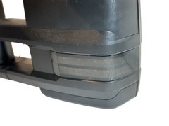 Close-up of a towing mirror exterior indicator lens and black housing