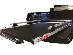 Black BEDSLIDE truck bed sliding platform with aluminum rails extended from a pickup bed