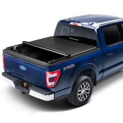 Blue Ford F-150 with a TruXedo TruXport soft roll-up tonneau cover partially open