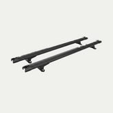 Pair of black IRONHAUL cross bars for an aluminum truck canopy