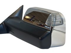 Close-up of a towing mirror chrome housing and clear indicator lens