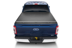 Rear view of a blue Ford F-150 with a closed TruXedo TruXport soft roll-up tonneau cover