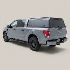 Ironhaul Ford F-150 Aluminum Truck Canopy V2, rear three-quarter view on a light neutral studio background