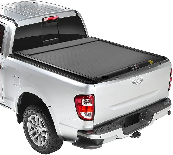 IRONHAUL hard retractable tonneau cover installed on a silver pickup truck on a white background